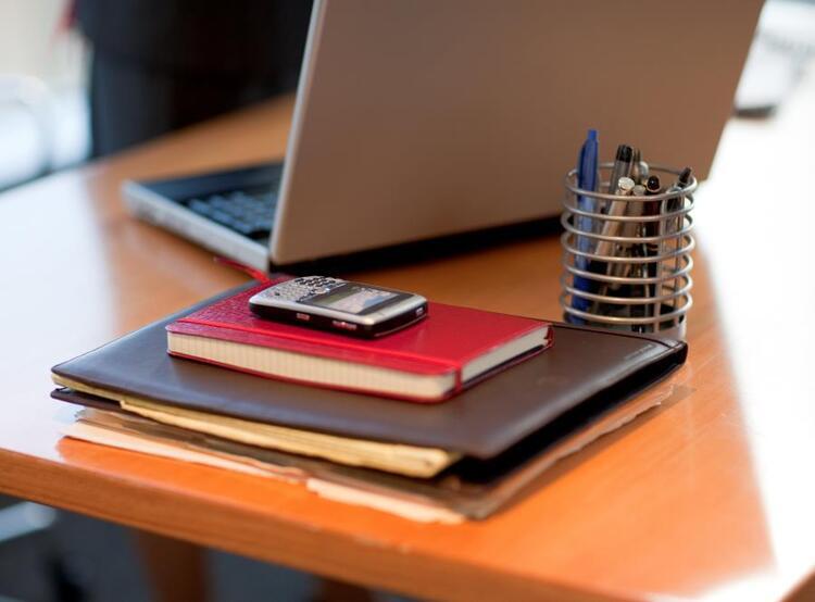 Desk with books and laptop